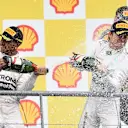 Race winner Lewis Hamilton (GBR) Mercedes AMG F1 and Nico Rosberg (GER) Mercedes AMG F1 celebrate on the podium with the champagne at Formula One World Championship, Rd11, Belgian Grand Prix, Race, Spa Francorchamps, Belgium, Sunday 23 August 2015. &copy; Sutton Motorsport Images