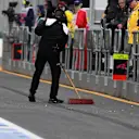 Mechanic sweeps pit lane at Formula One World Championship, Rd1, Australian Grand Prix, Qualifying, Albert Park, Melbourne, Australia, Saturday 19 March 2016. &copy; Sutton Motorsport Images
