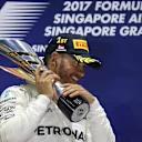 Race winner Lewis Hamilton (GBR) Mercedes AMG F1 celebrates on the podium with the trophy at Formula One World Championship, Rd14, Singapore Grand Prix, Race, Marina Bay Street Circuit, Singapore, Sunday 17 September 2017. © Mirko Stange/Sutton Images