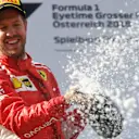 Sebastian Vettel (GER) Ferrari celebrates on the podium with the champagne at Formula One World Championship, Rd9, Austrian Grand Prix, Race, Spielberg, Austria, Sunday 1 July 2018. © Mark Sutton/Sutton Images