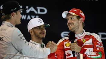World Champion Nico Rosberg (GER) Mercedes AMG F1 celebrates on the podium with Sebastian Vettel