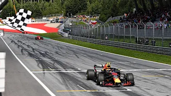Race winner Max Verstappen (NED) Red Bull Racing RB14 takes the chequered flag at Formula One World