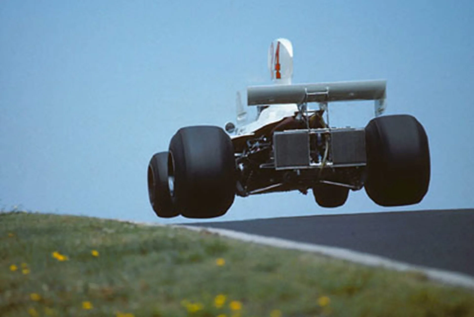 Nurburgring, August 1975: James Hunt takes to the air in his Hesketh at the German Grand Prix. He