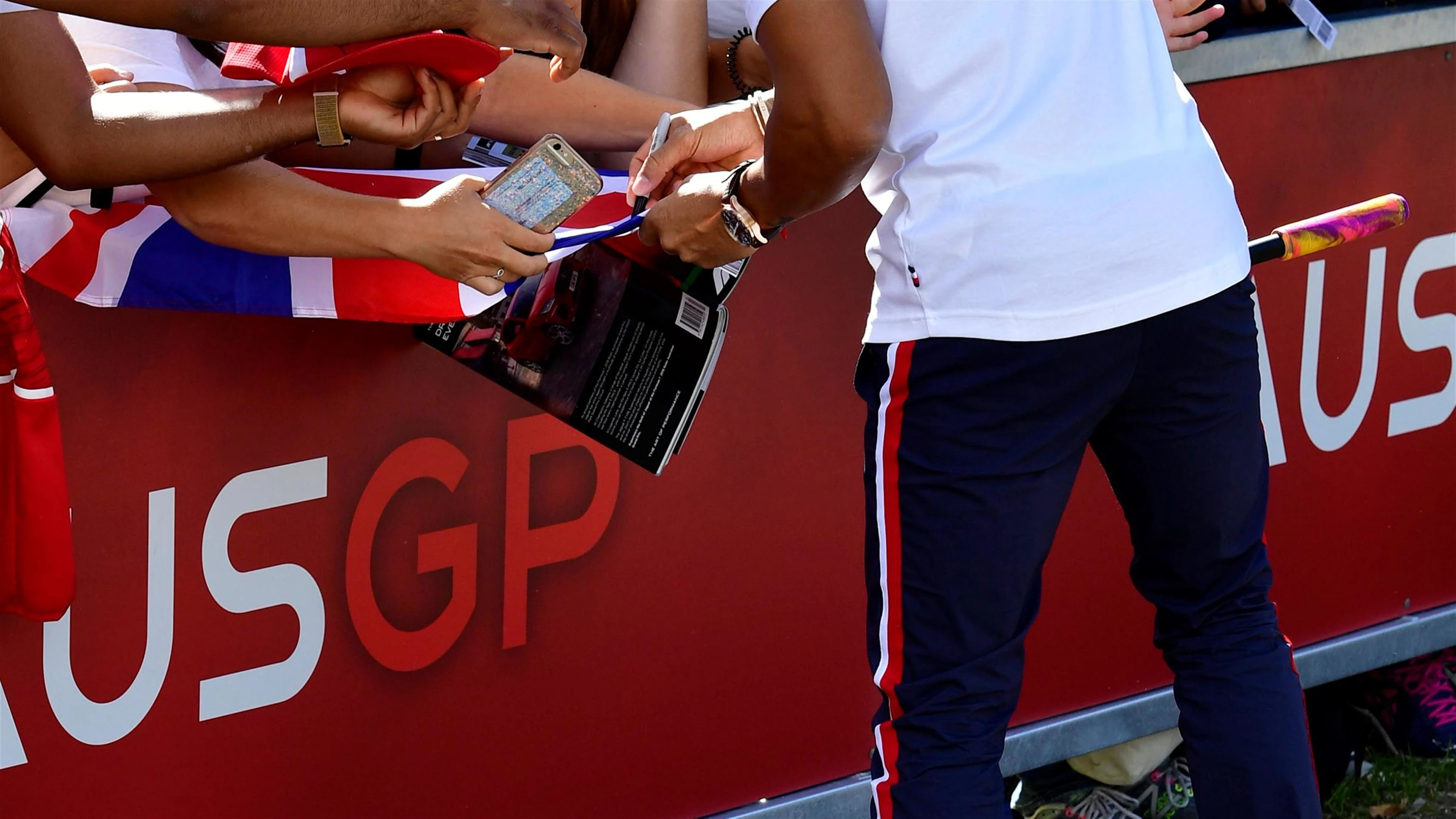 Lewis Hamilton (GBR) Mercedes-AMG F1 on a scooter signs autographs for the fans at Formula One