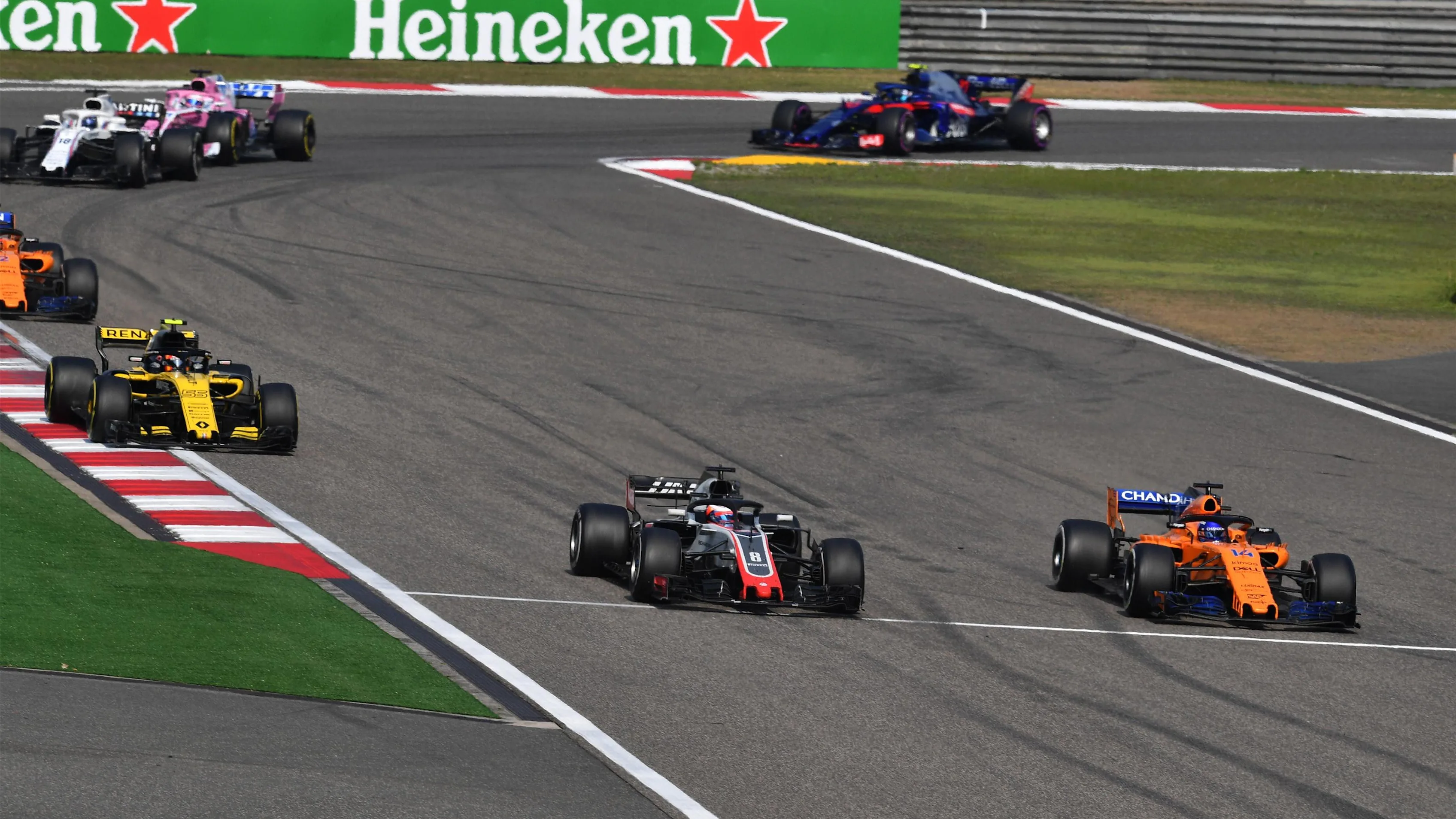 Romain Grosjean (FRA) Haas VF-18 and Fernando Alonso (ESP) McLaren MCL33 battle at Formula One World Championship, Rd3, Chinese Grand Prix, Race, Shanghai, China, Sunday 15 April 2018. © Mark Sutton/Sutton Images