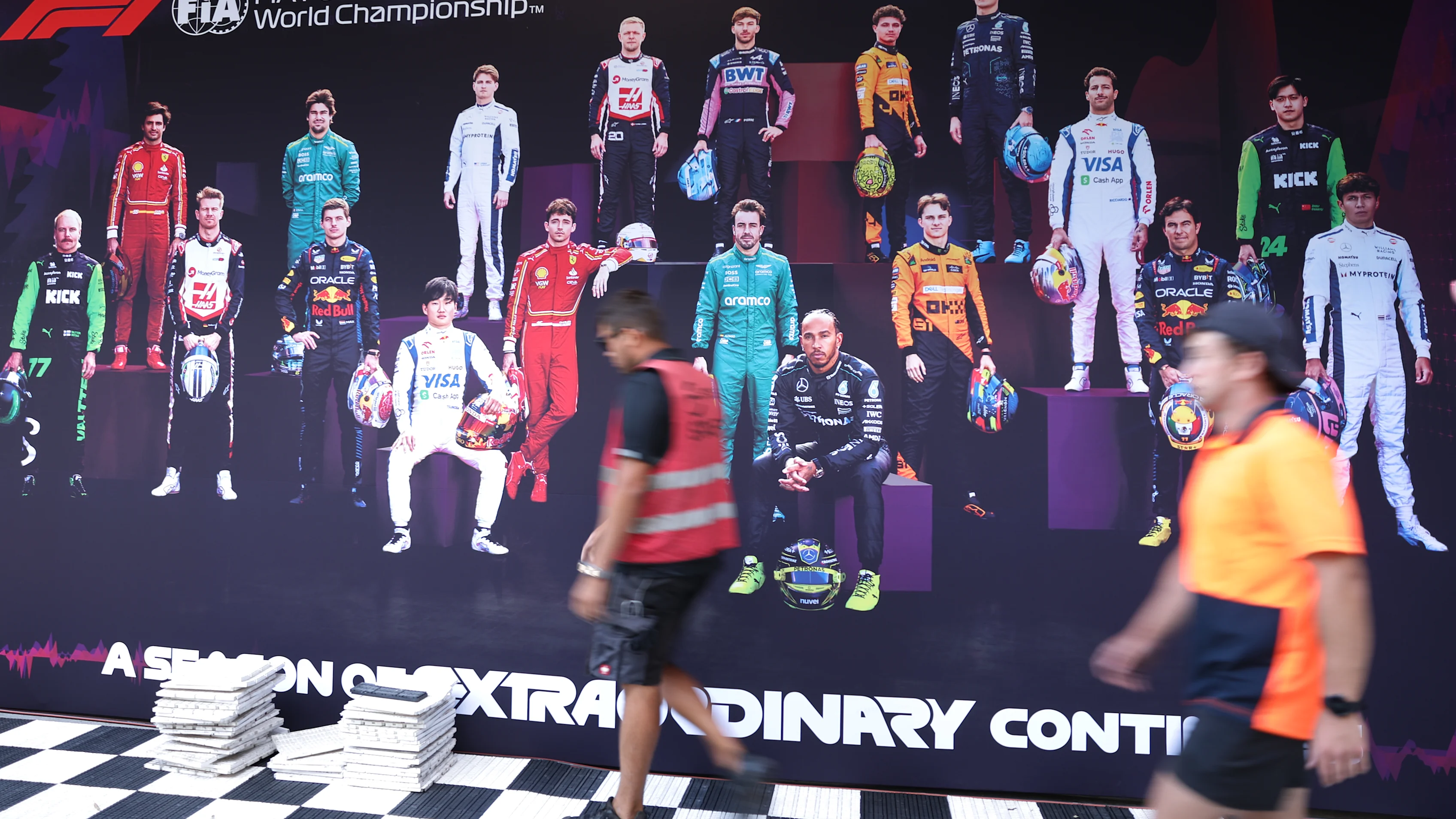 MELBOURNE, AUSTRALIA - MARCH 21: Workers put the finishing touches to pit paddock during previews